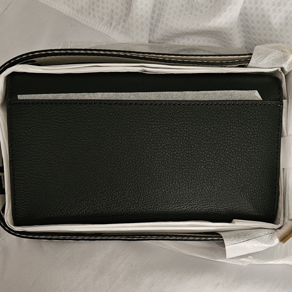 Chic black crossbody with gold accents and bold logo strap.
Perfect for everyday - Picture 8 of 10